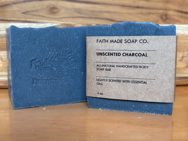 Charcoal soap bar with a label on a wooden surface
